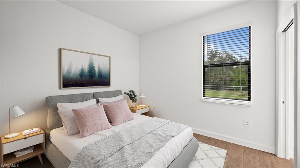 21090 Verawood Loop Estero, FL 33928 - Photo 16 of 17 a bedroom with a bed and wooden floor