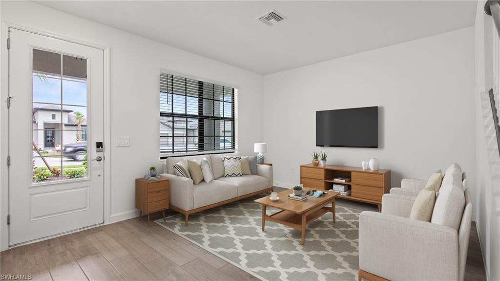 21090 Verawood Loop Estero, FL 33928 - Photo 5 of 17 a living room with furniture and a flat screen tv