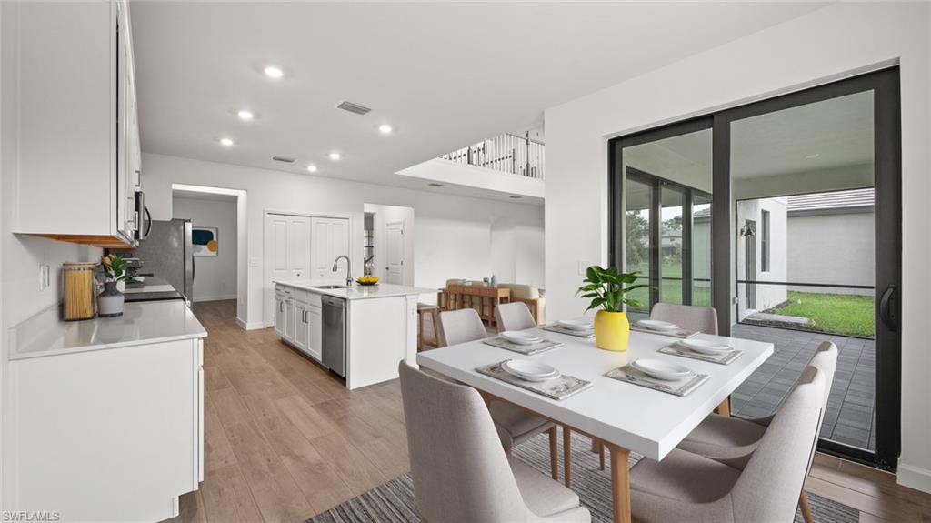 21090 Verawood Loop Estero, FL 33928 - Photo 7 of 17 a view of a dining room with furniture and a kitchen