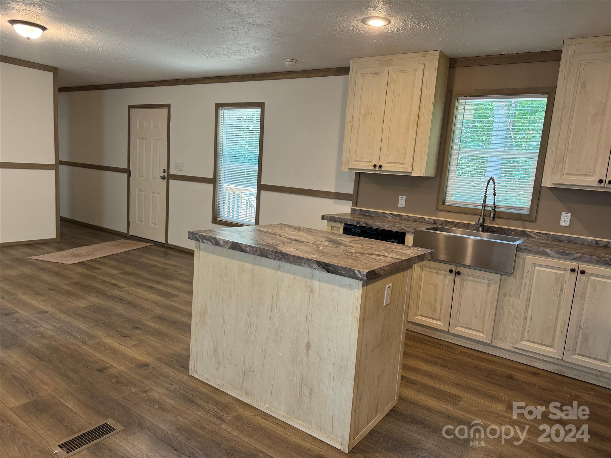 4730 Crystal Creek Road Morganton, NC 28655 - Photo 14 of 17 a kitchen with kitchen island granite countertop a sink cabinets and stainless steel appliances