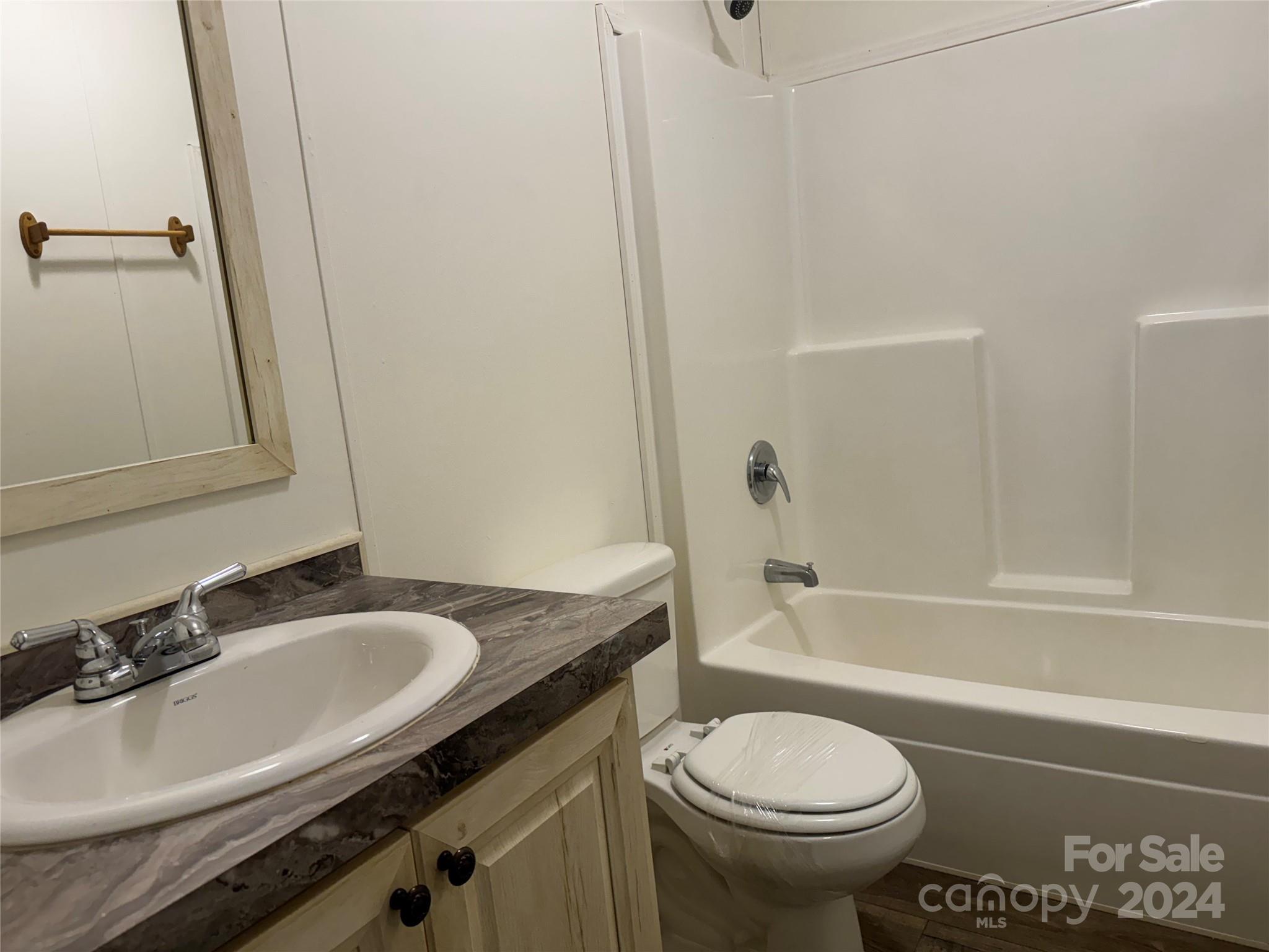 4730 Crystal Creek Road Morganton, NC 28655 - Photo 16 of 17 a bathroom with a granite countertop sink toilet and shower