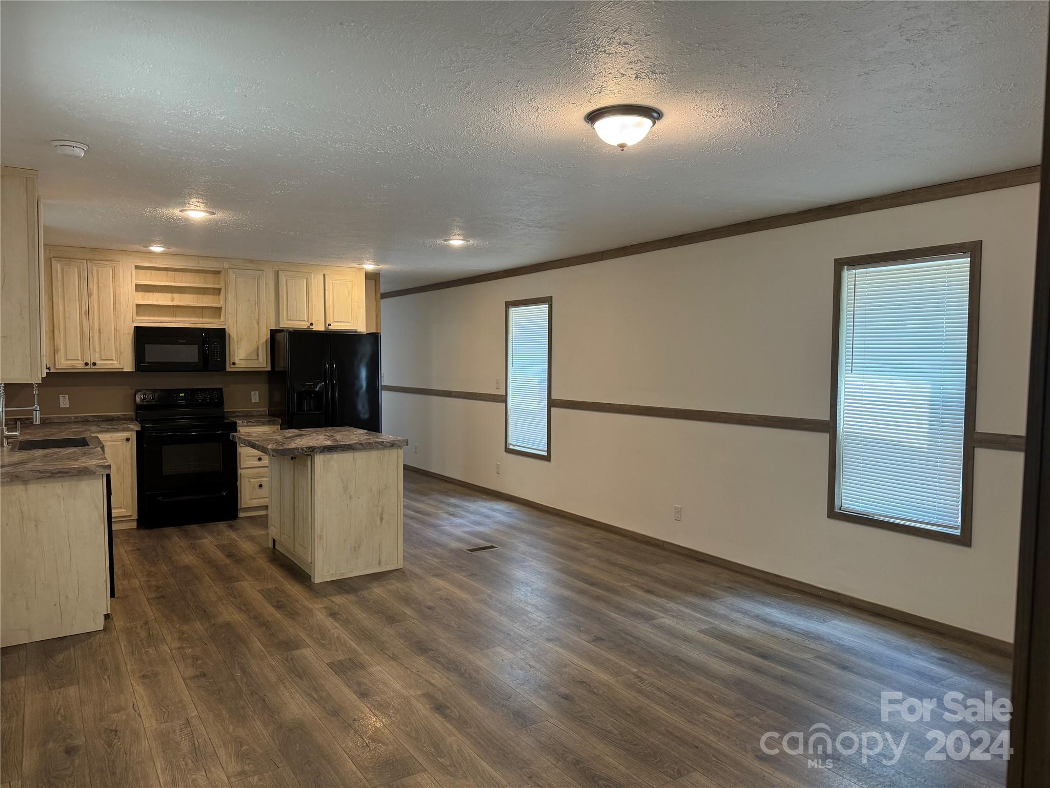 4730 Crystal Creek Road Morganton, NC 28655 - Photo 8 of 17 a kitchen with stainless steel appliances a refrigerator stove microwave and sink
