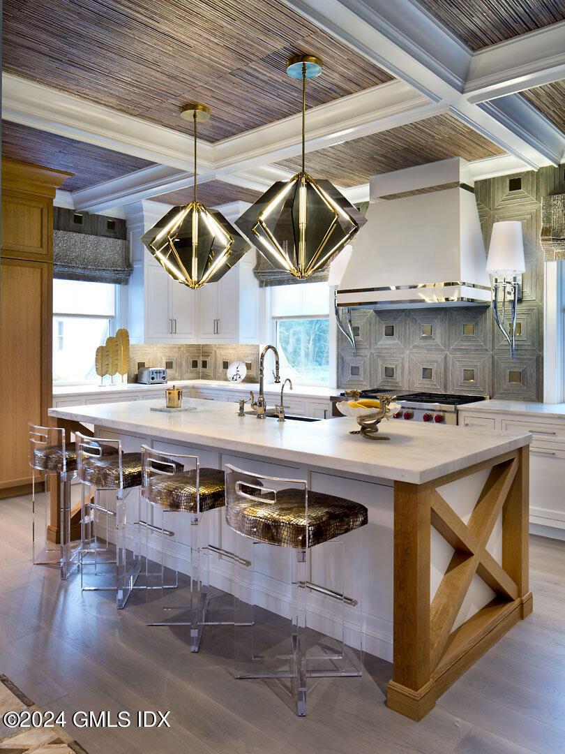 a kitchen with a stove a table and chairs