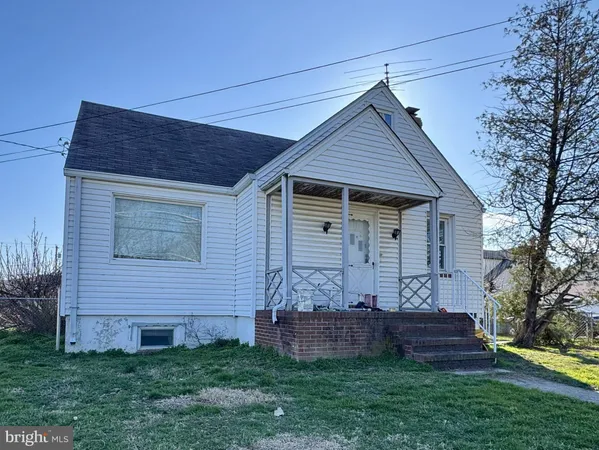 a front view of house with a garden