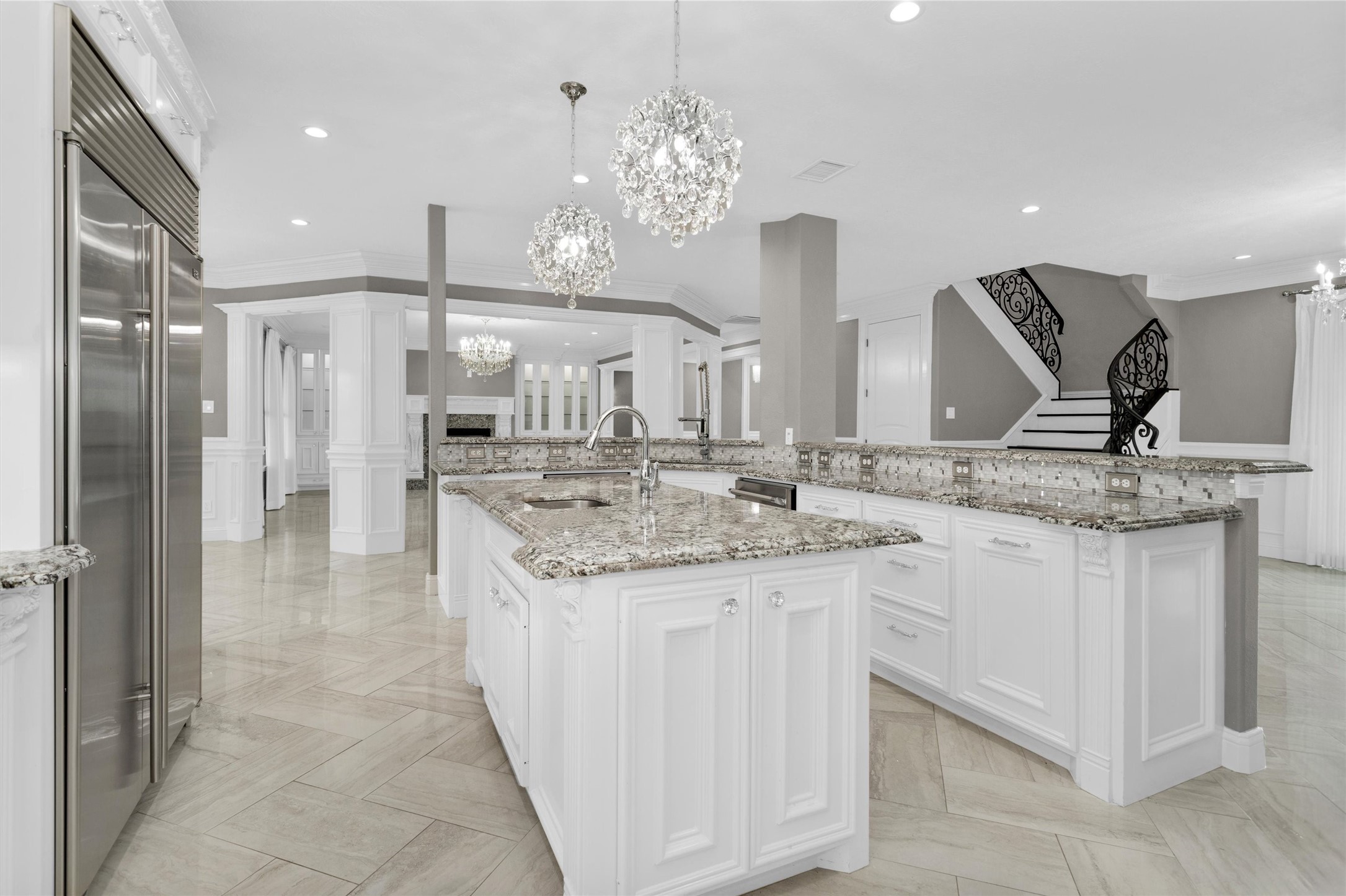 10887 Decatur Street Willis, TX 77318 - Photo 15 of 50 Designed for both function and flow — wraparound counters, bar seating, and open views into the main living areas make this kitchen ideal for hosting while keeping everything within reach.