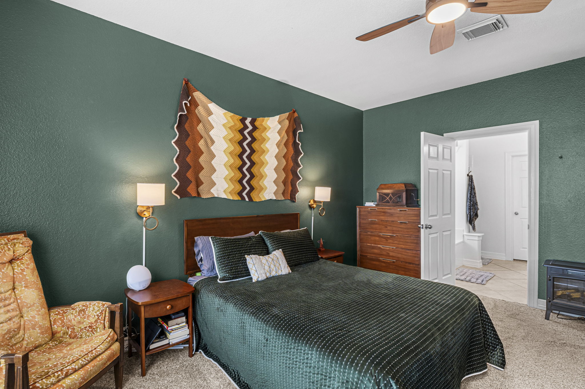 454 Fall Circle Kyle, TX 78640 - Photo 18 of 39 A comforting bedroom with a ceiling fan overhead, offering a peaceful retreat.