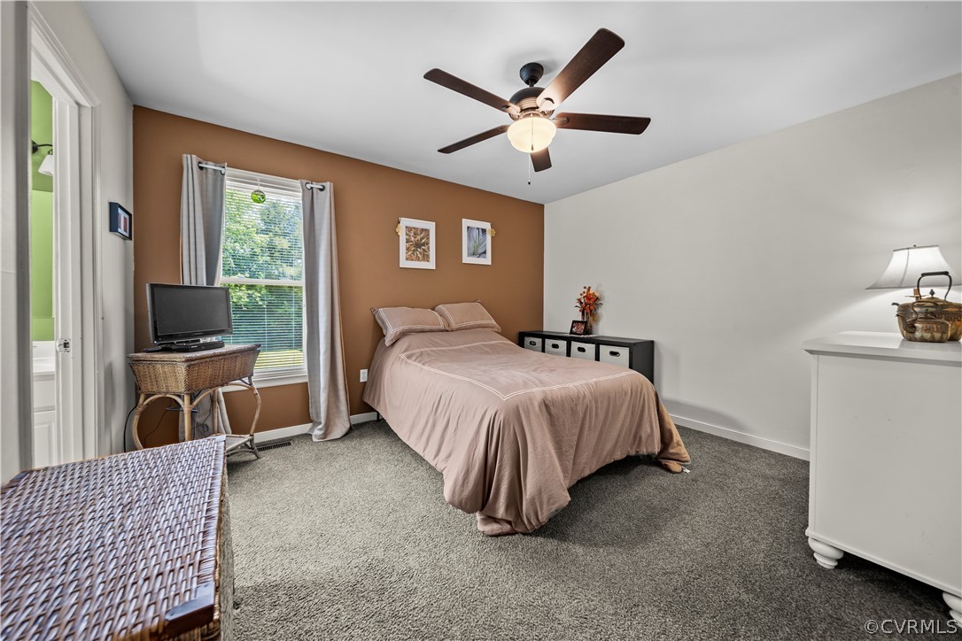 4833 Wilconna Road Chesterfield, VA 23832 - Photo 17 of 29 a spacious bedroom with a bed a couch and a flat screen tv