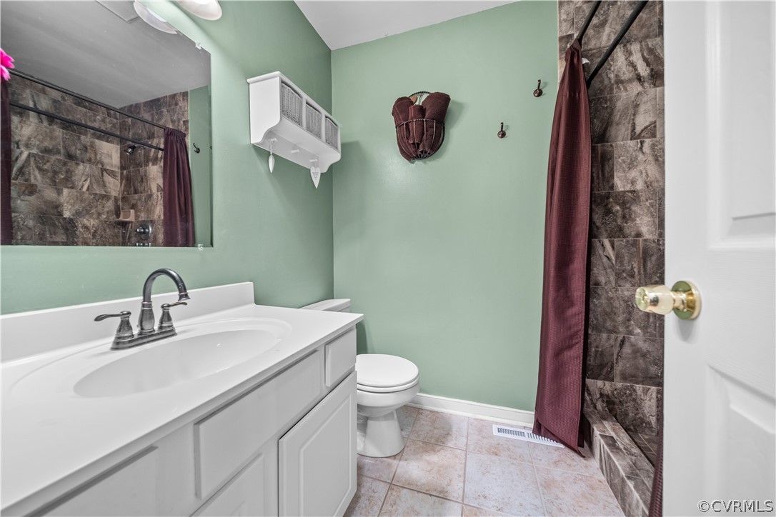 4833 Wilconna Road Chesterfield, VA 23832 - Photo 23 of 29 a bathroom with a sink mirror vanity and toilet