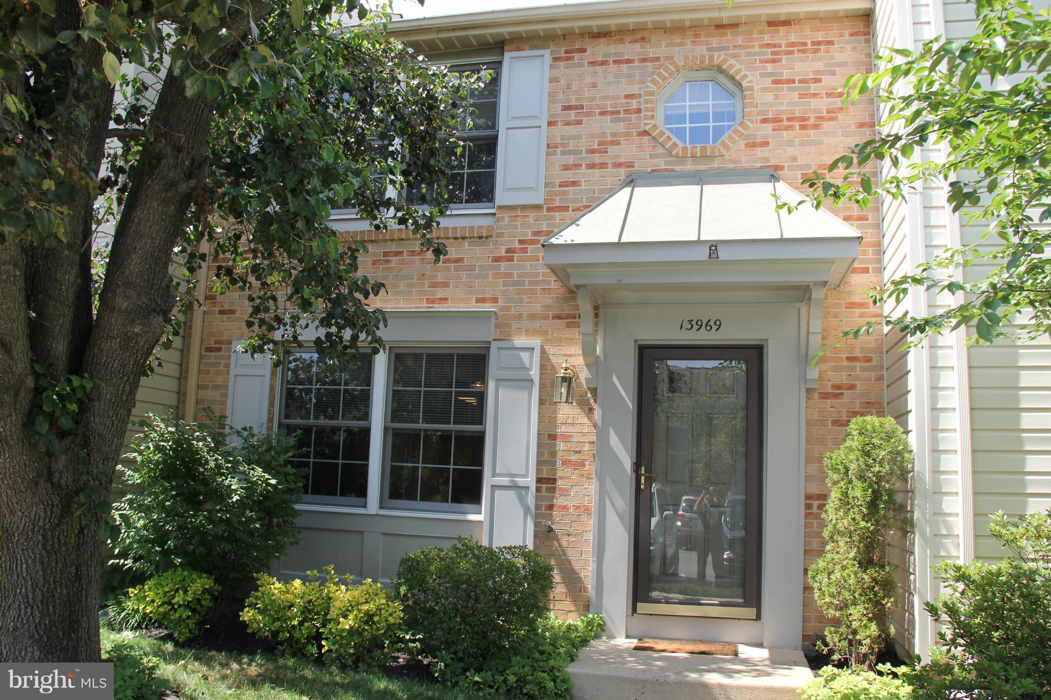 13969 Baton Rouge Court Centreville, VA 20121 - Photo 1 of 20 a front view of a house with a garden