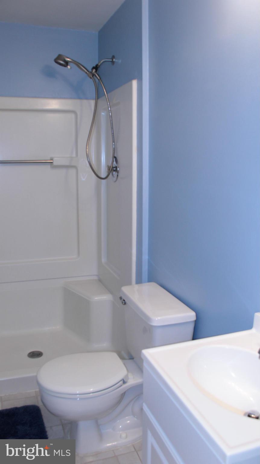 13969 Baton Rouge Court Centreville, VA 20121 - Photo 15 of 20 a white toilet sitting next to a bath tub and a shower