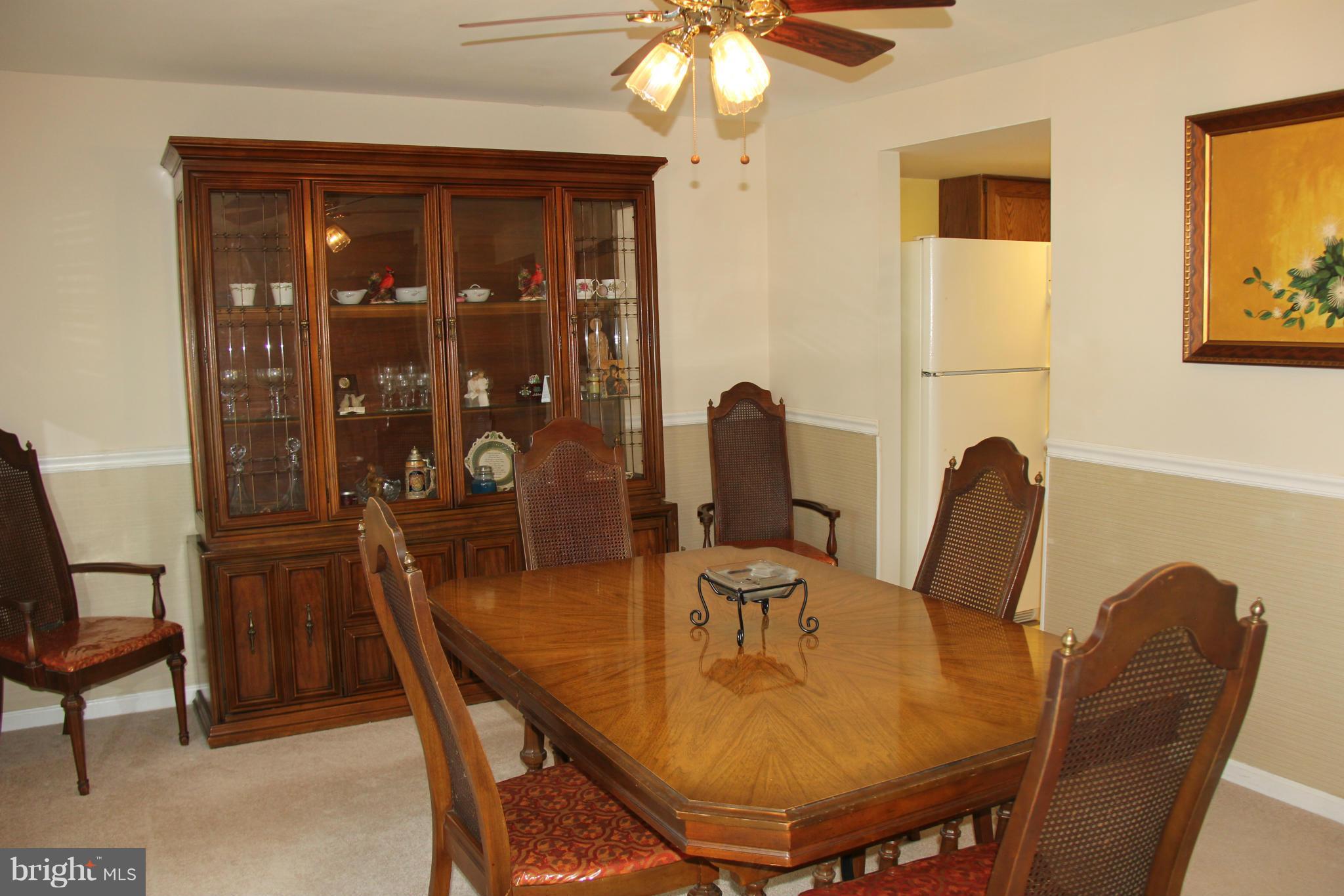 13969 Baton Rouge Court Centreville, VA 20121 - Photo 3 of 20 a view of a dining room with furniture and chandelier