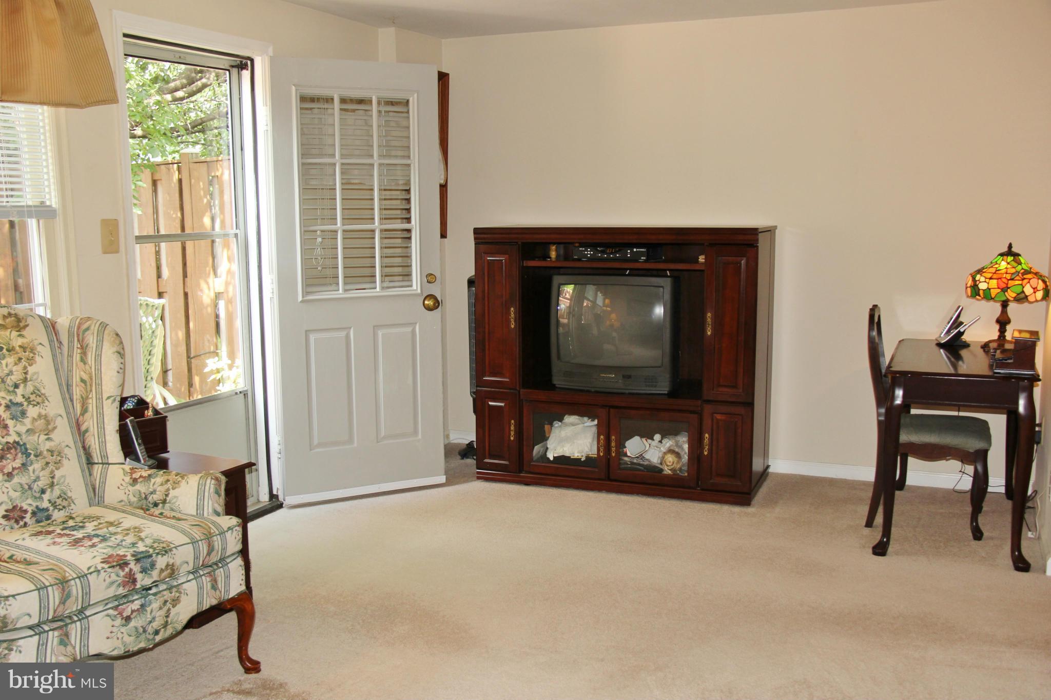 13969 Baton Rouge Court Centreville, VA 20121 - Photo 8 of 20 a living room with furniture a flat screen tv and a fireplace
