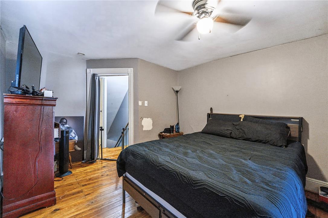 1030 Monocacy Street Bethlehem, PA 18018 - Photo 15 of 34 Rich hardwood flooring anchors this cozy bedroom space situated near the stairs.