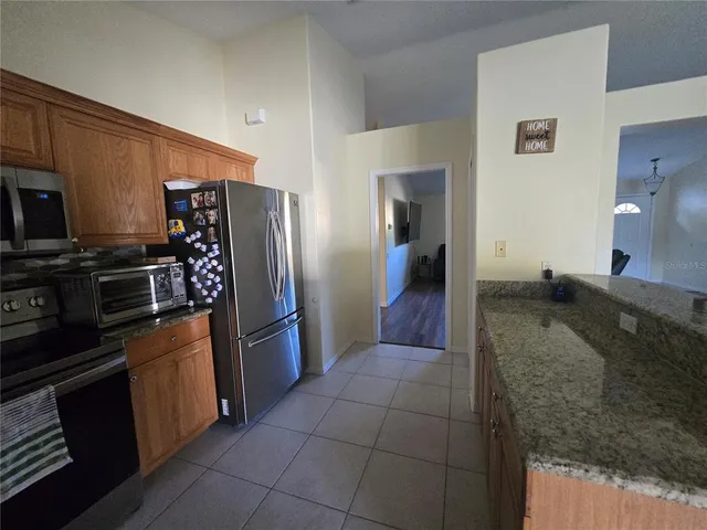 a kitchen with a refrigerator and a sink