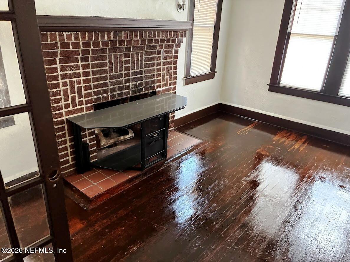 2036 Moncrief Road Jacksonville, FL 32209 - Photo 7 of 32 a view of an empty room with wooden floor and a window