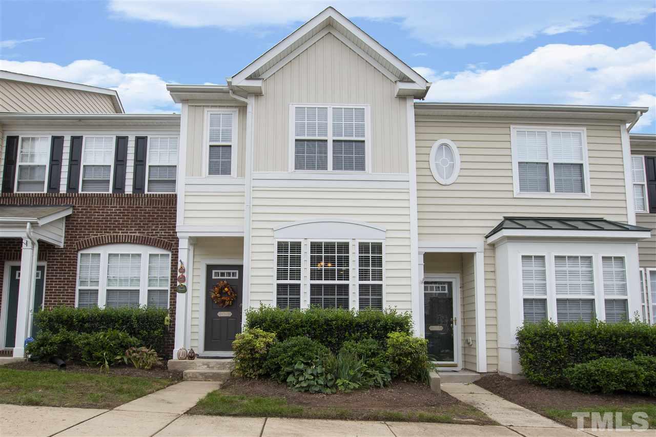7879 Spungold Street Raleigh, NC 27617 - Photo 1 of 25 a front view of a house with a yard and potted plants