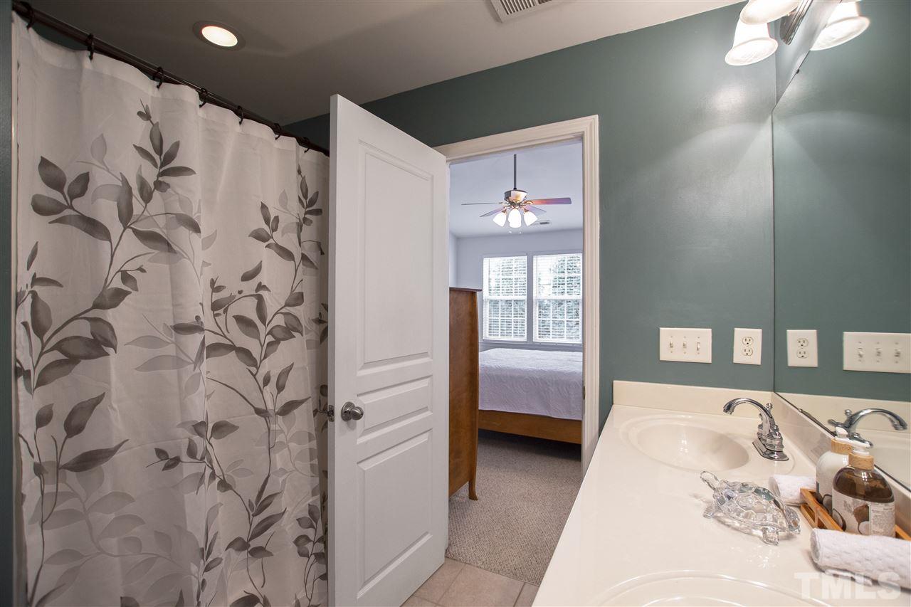 7879 Spungold Street Raleigh, NC 27617 - Photo 14 of 25 a bedroom with a bed and a couch