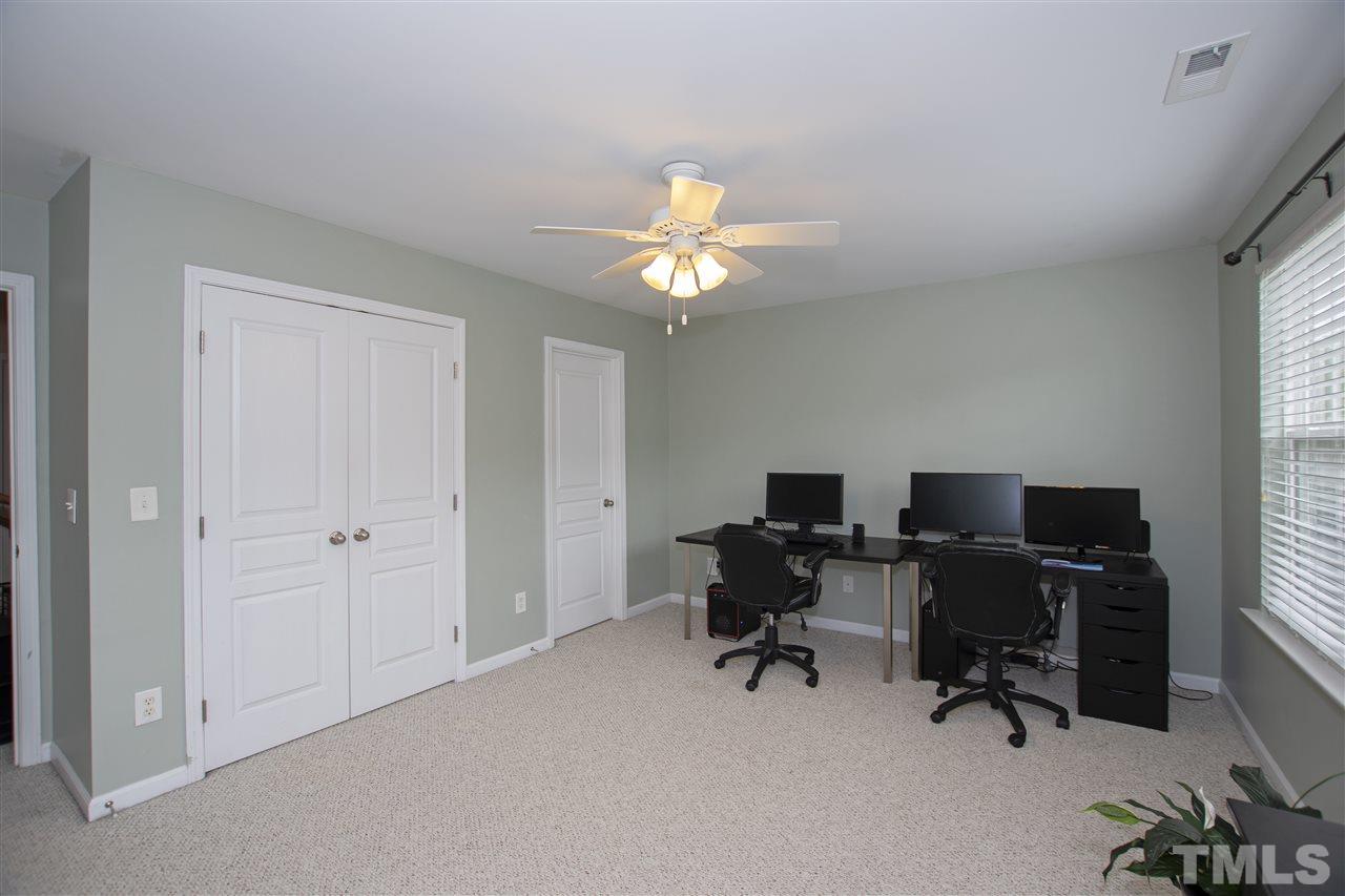 7879 Spungold Street Raleigh, NC 27617 - Photo 20 of 25 a view of a workspace with furniture and a window