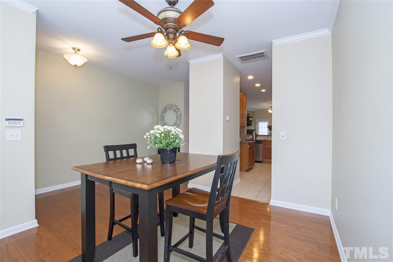 7879 Spungold Street Raleigh, NC 27617 - Photo 3 of 25 a view of a dining room with furniture and chandelier