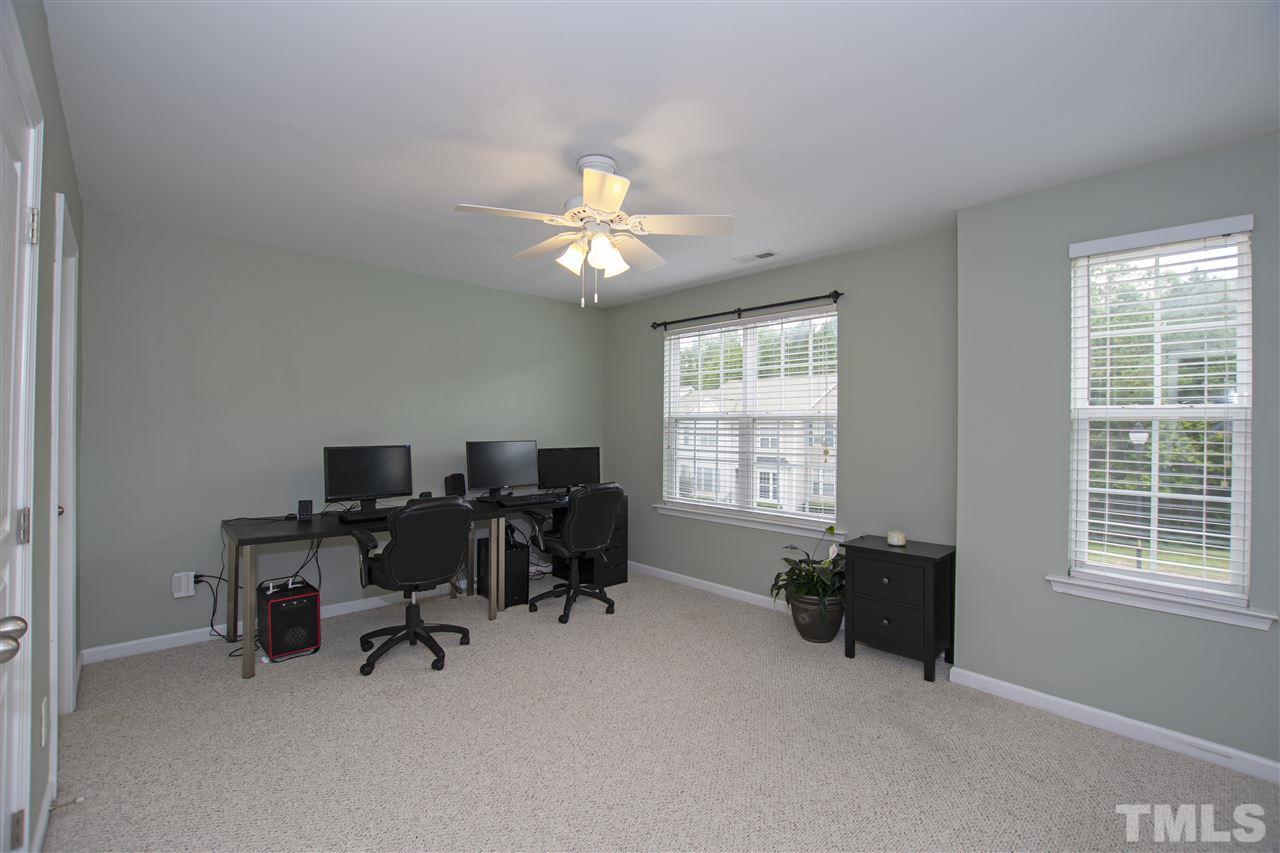 7879 Spungold Street Raleigh, NC 27617 - Photo 21 of 25 a view of a workspace with furniture and a window