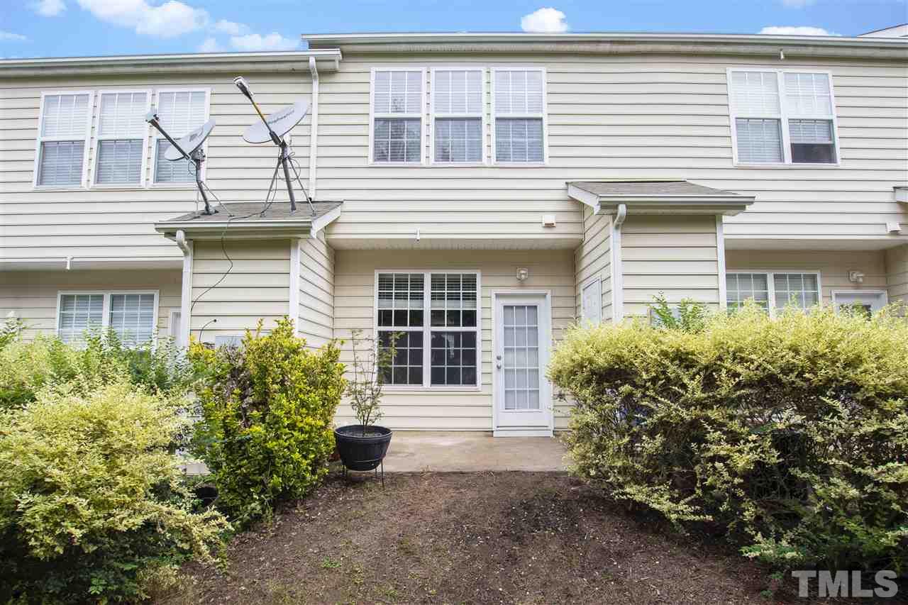 7879 Spungold Street Raleigh, NC 27617 - Photo 23 of 25 a front view of a house with garden