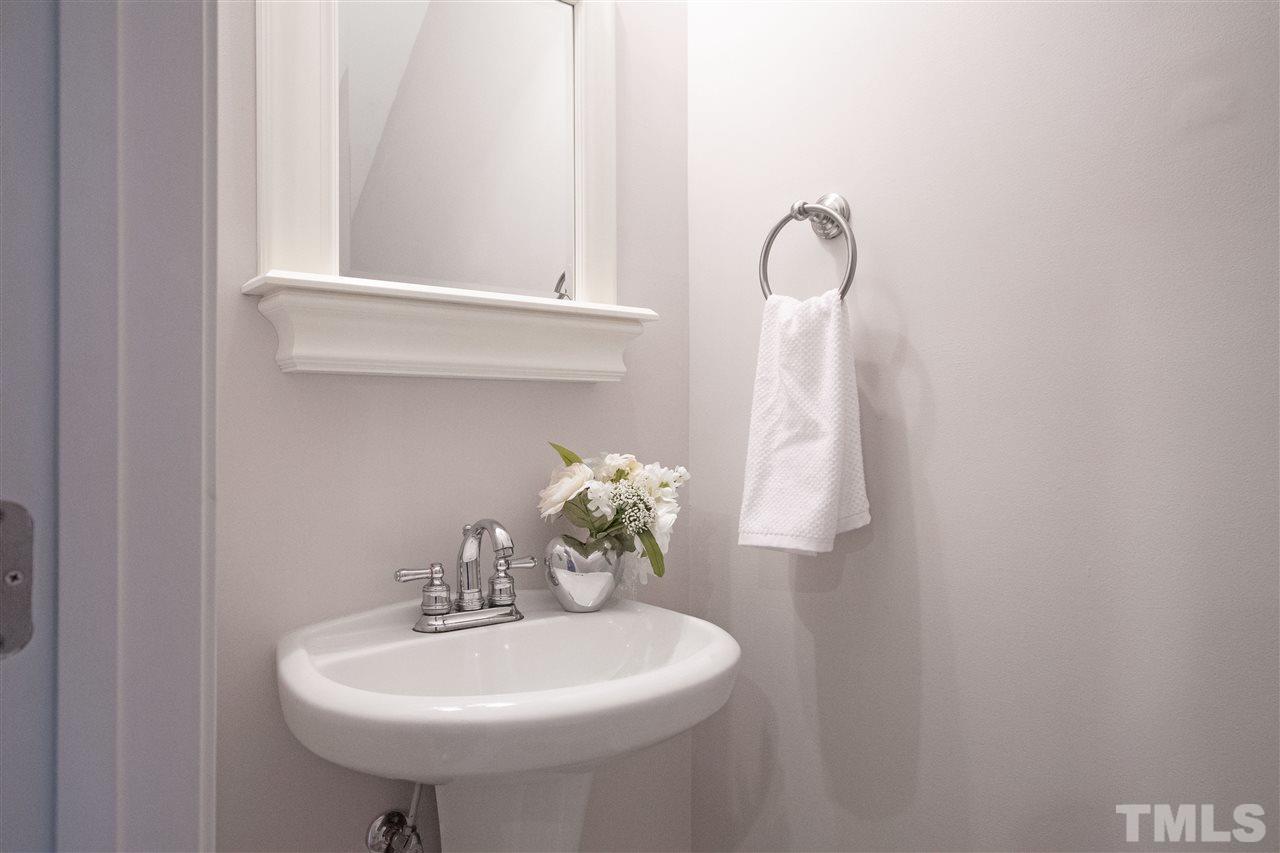 7879 Spungold Street Raleigh, NC 27617 - Photo 10 of 25 a bathroom with a sink a and a mirror