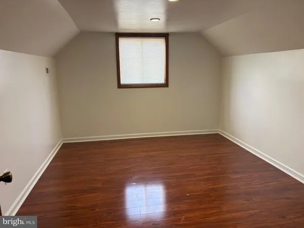 a view of a room with wooden floor and window