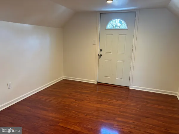 a view of an empty room and wooden floor
