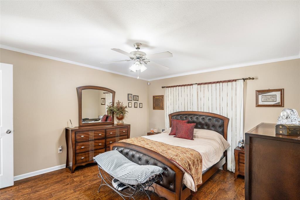 360 Rockcrest Road New Hope, TX 75071 - Photo 18 of 20 a bedroom with a bed and a chandelier