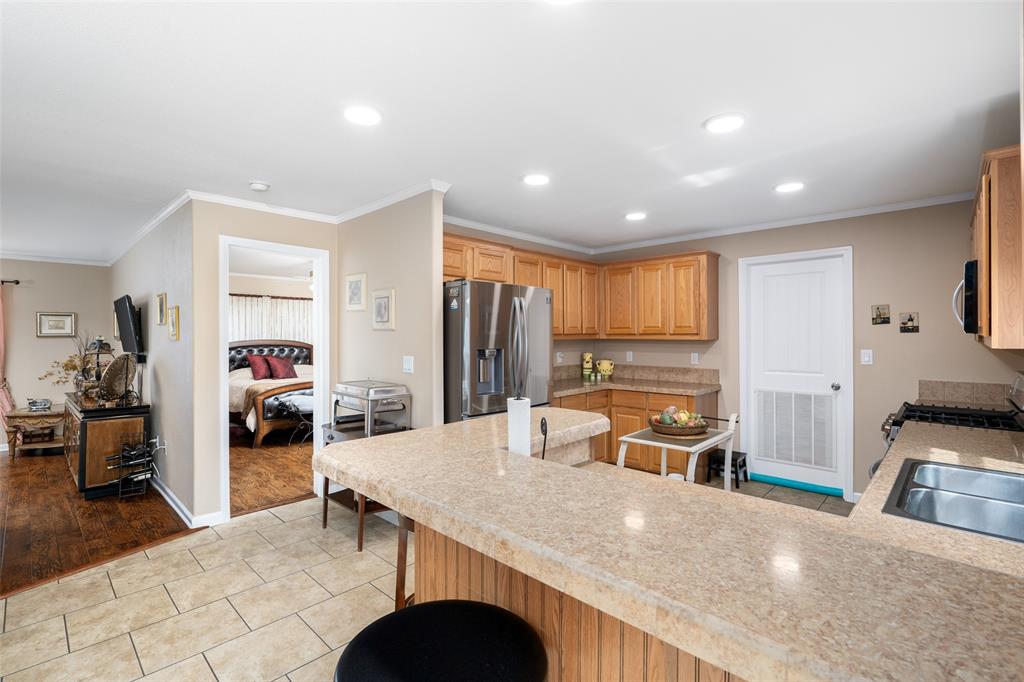 360 Rockcrest Road New Hope, TX 75071 - Photo 7 of 20 a kitchen with stainless steel appliances granite countertop a refrigerator a sink a stove and island