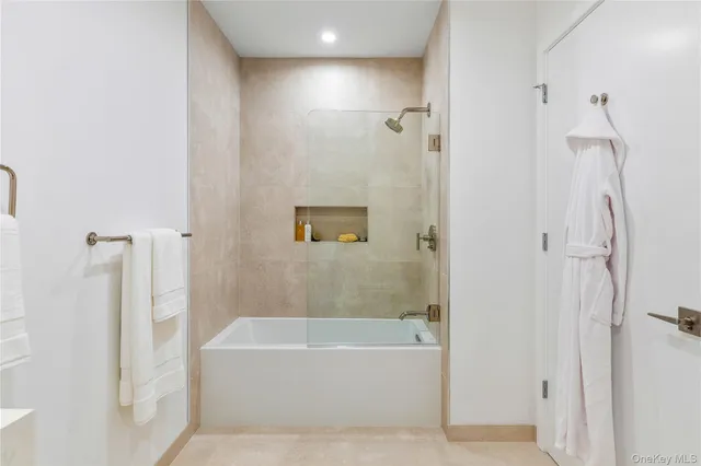a bathroom with a bathtub and shower