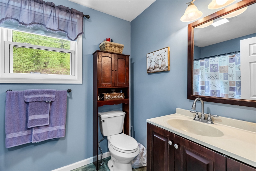 302 Middlefield Road Chester, MA 01011 - Photo 17 of 42 a bathroom with a toilet a sink and a large mirror