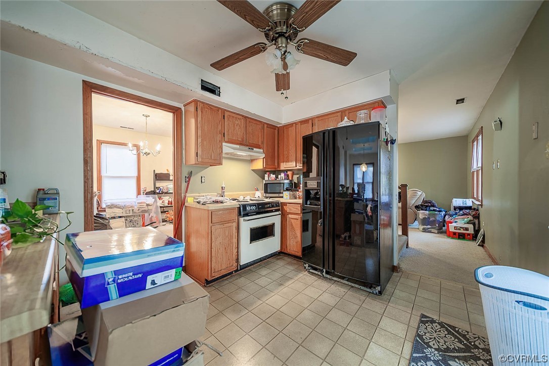 5813 Mill Spring Road Midlothian, VA 23112 - Photo 6 of 7 a kitchen with a refrigerator a oven a sink a dining table and chairs