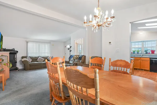 a view of a dining room with furniture and a chandelier