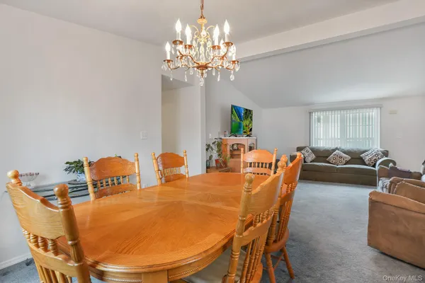 a dining room with furniture and chandelier