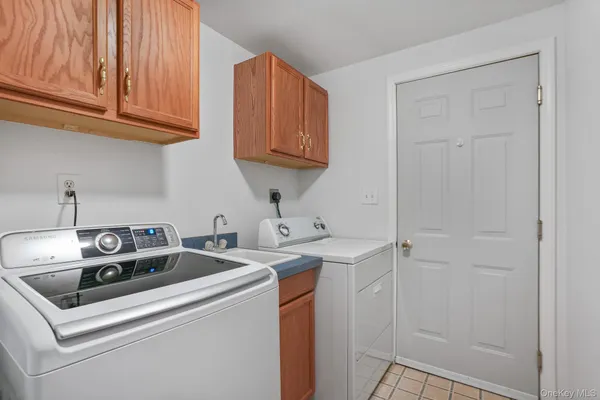a utility room with stainless steel appliances granite countertop a sink and a stove