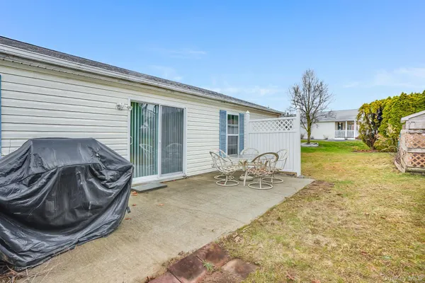 a view of a patio with chair and tables