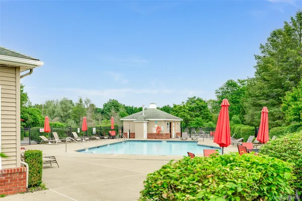 a aerial view of a house with swimming pool and a yard