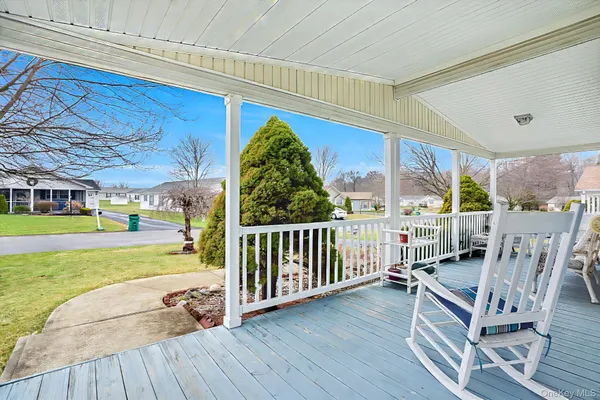 a view of a living room and a wooden deck