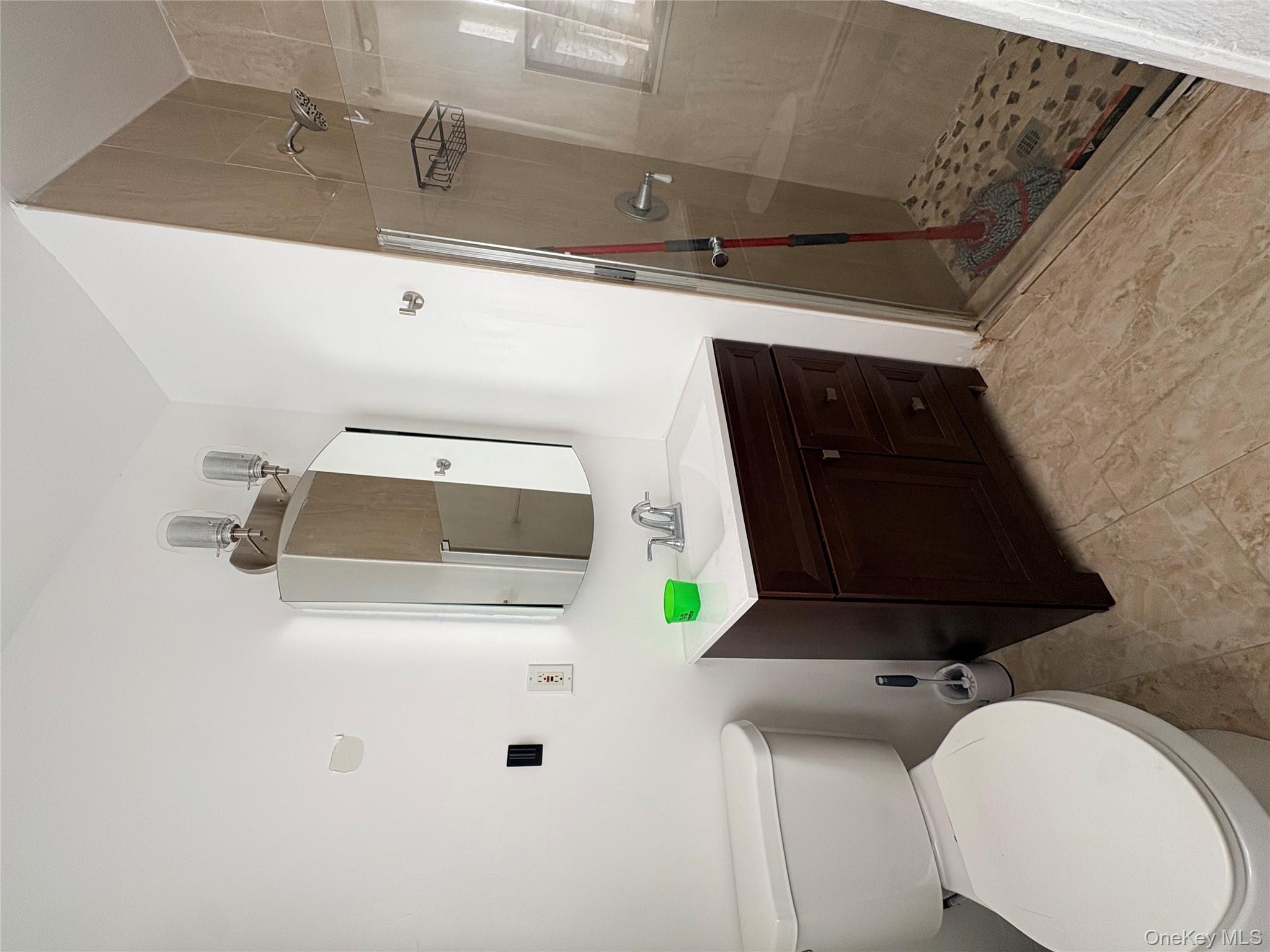 77 Upper Road Middletown, NY 10940 - Photo 13 of 21 a bathroom with a sink vanity mirror and toilet