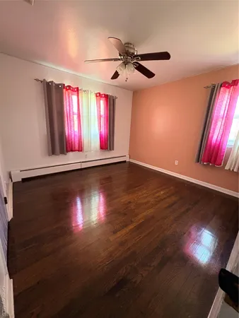 a view of room with hardwood floor and window
