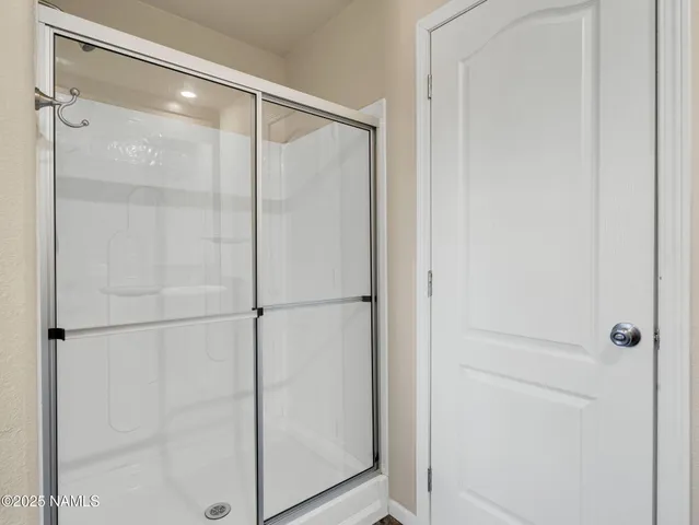 a bathroom with a glass shower door