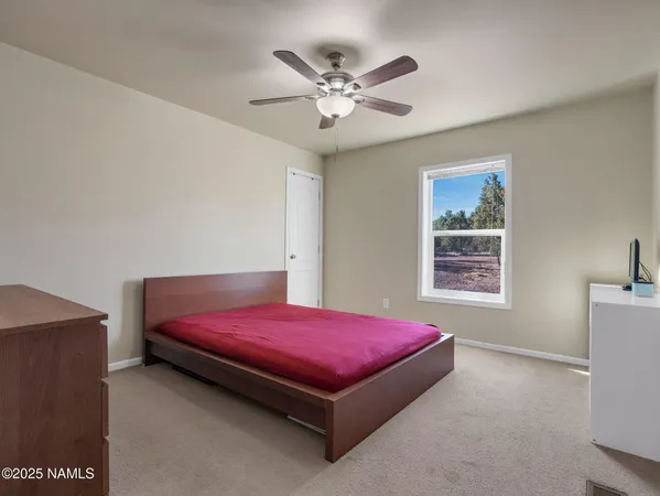 a bedroom with a bed and window