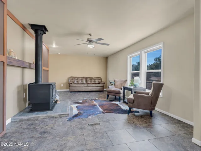 a living room with furniture a chandelier and a piano