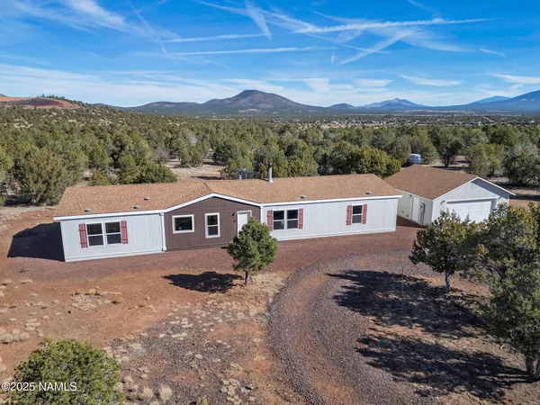 an aerial view of residential house and a yard