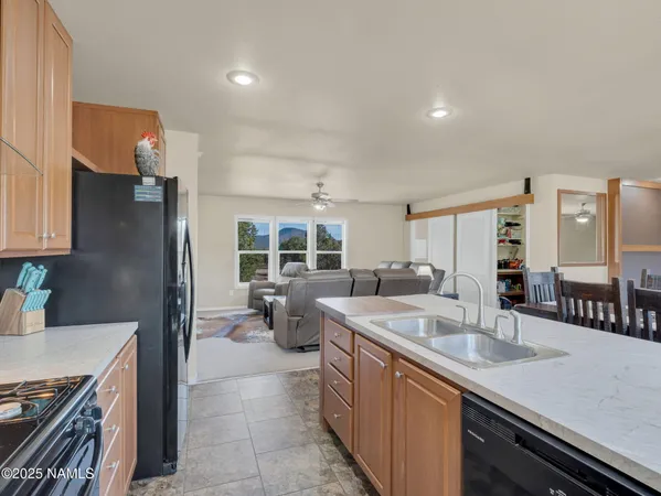a kitchen with sink refrigerator and stove