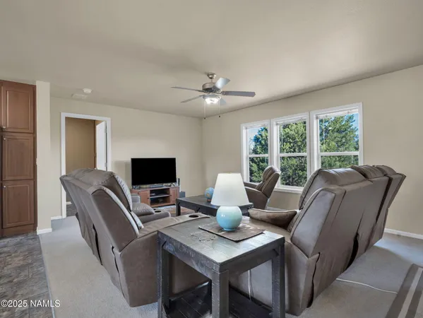 a workspace with furniture and a large window