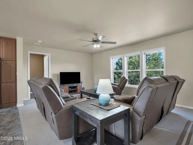 a workspace with furniture and a large window