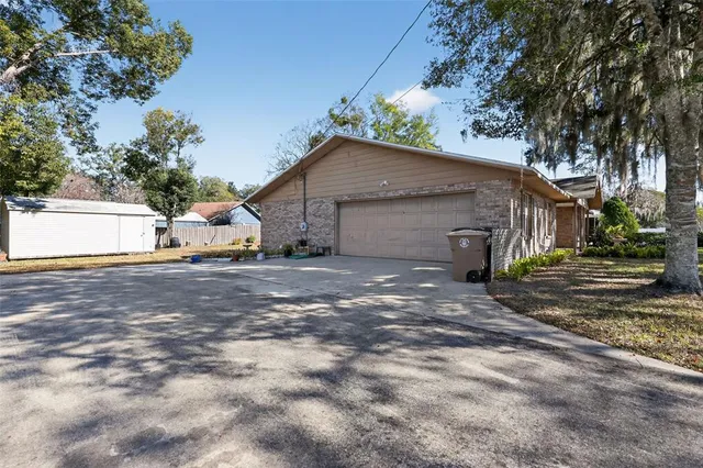 a view of a house with a yard and garage