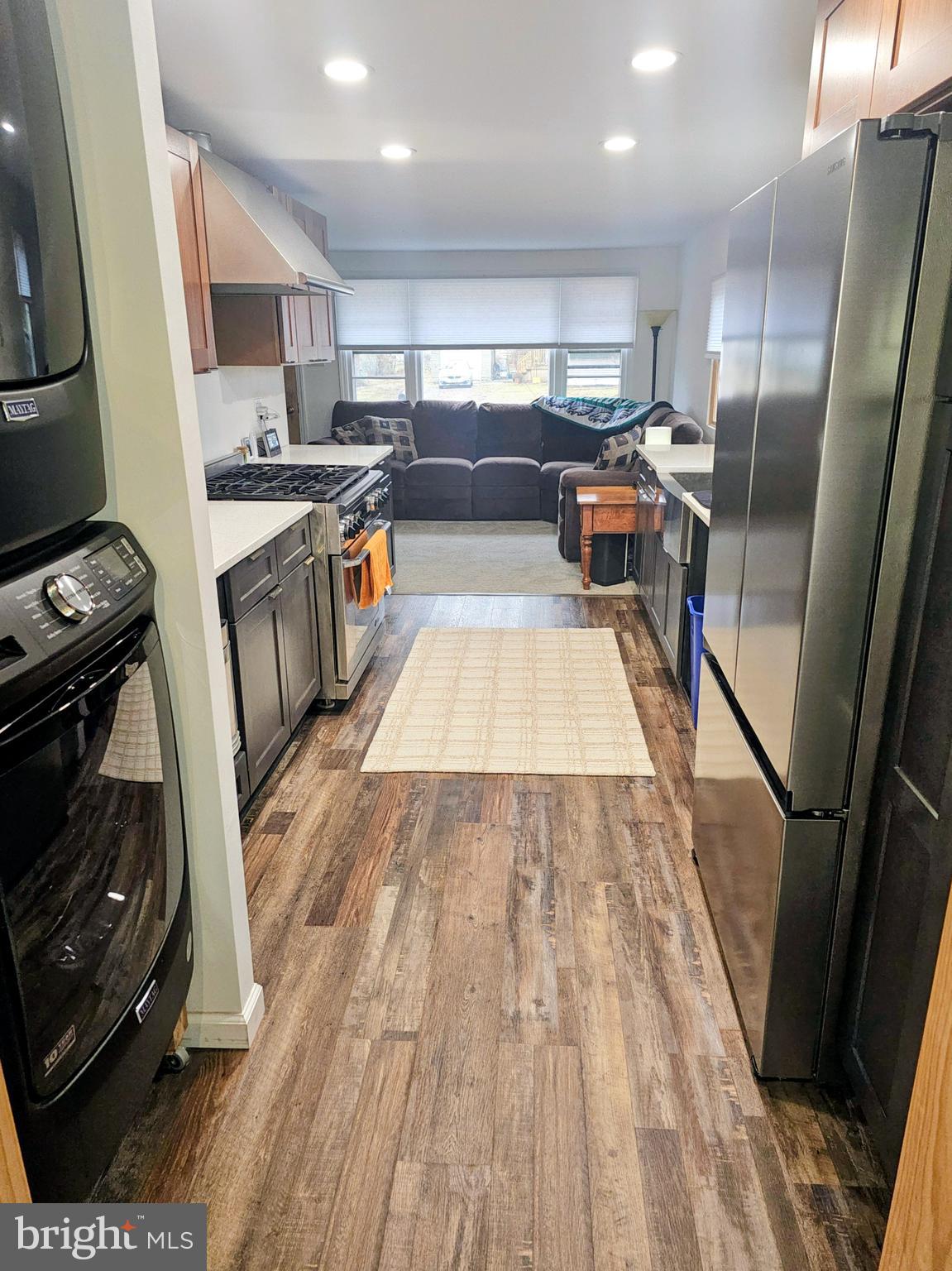 2891 Union Road Vineland, NJ 08361 - Photo 3 of 25 a kitchen with stainless steel appliances granite countertop a refrigerator a sink dishwasher a stove and white countertops with wooden floor